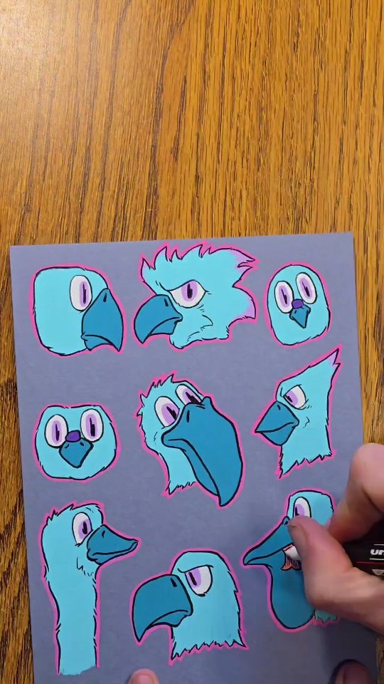 Nine teal bird heads with purple eyes and hot pink outlines painted on slate blue paper.