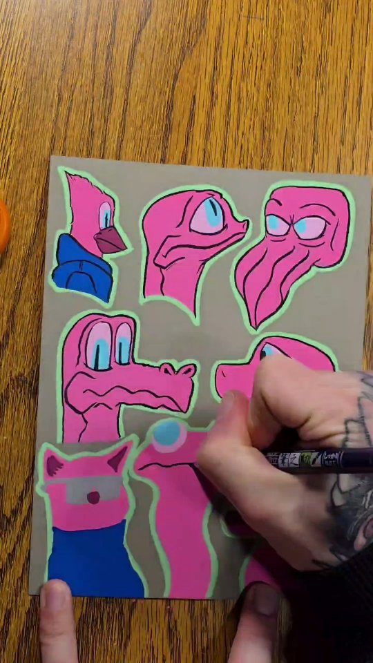 Pink lizard and bird characters with blue accents and glowing green outlines, painted on kraft-brown paper.