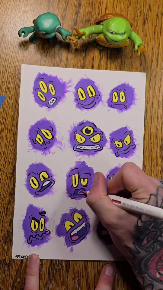 Twelve scruffy purple blob monsters with big yellow eyes, one a cyclops, painted loosely on white paper.